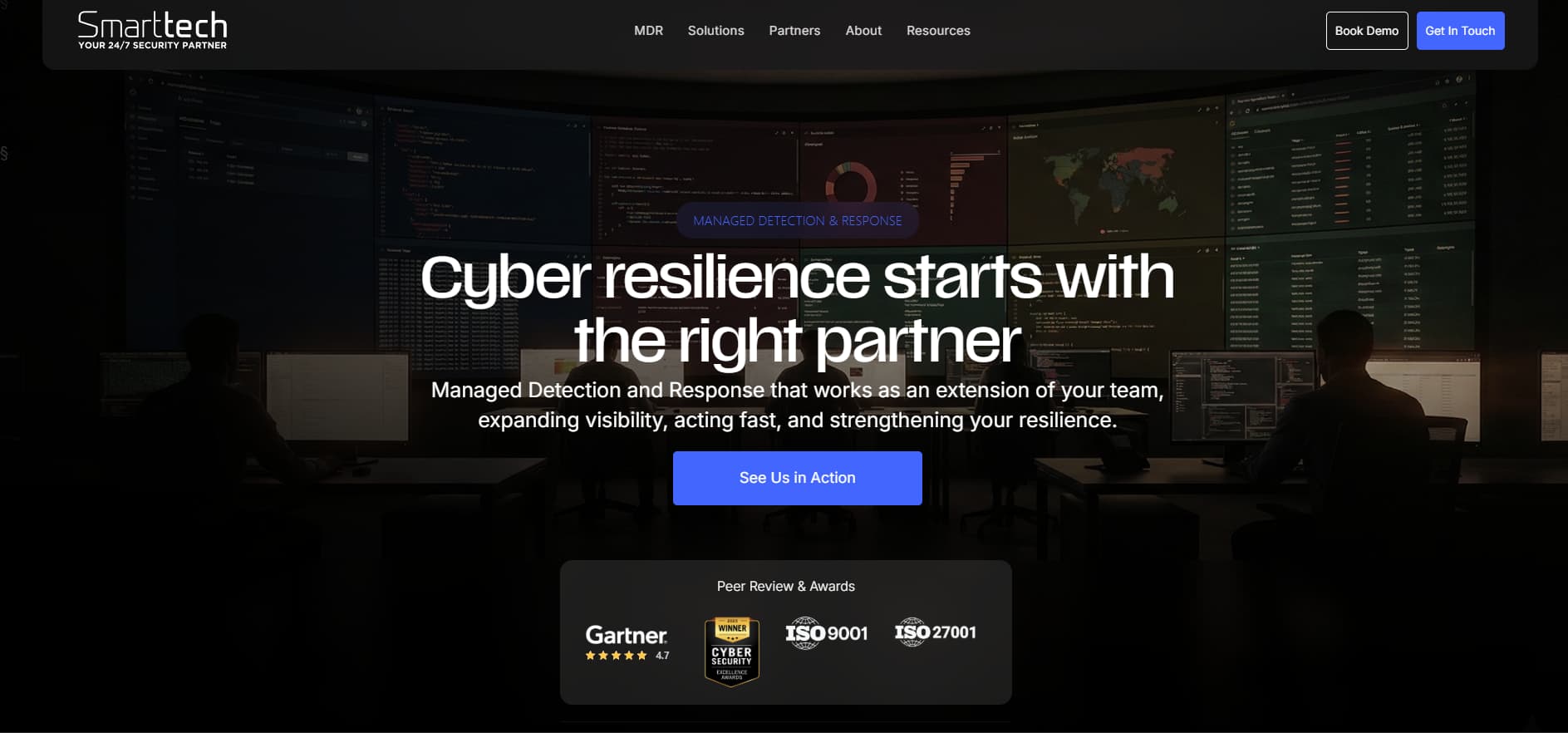 Dark cybersecurity operations center scene showing multiple large monitoring screens, the headline “Cyber resilience starts with the right partner,” and a blue call-to-action button.