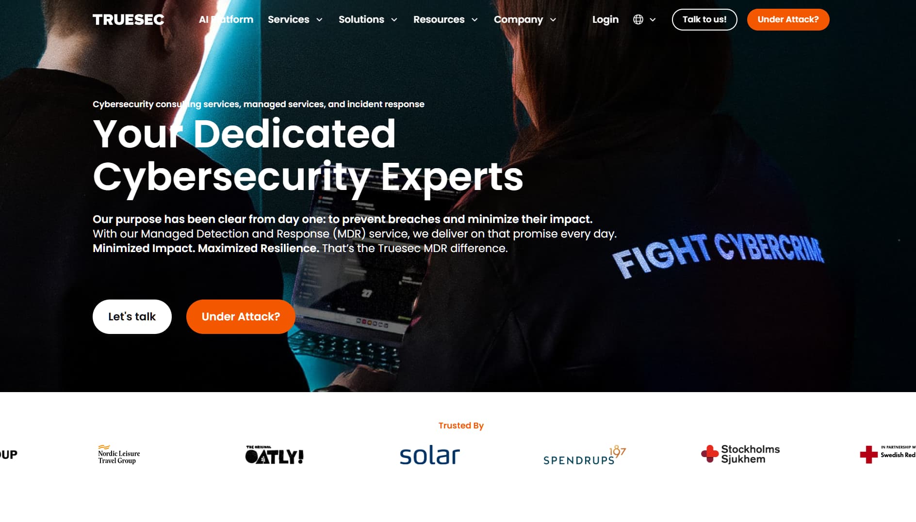 Screenshot of Truesec homepage displaying a cybersecurity expert in a dark setting with the slogan ‘Your Dedicated Cybersecurity Experts’ and a jacket labeled ‘Fight Cybercrime.