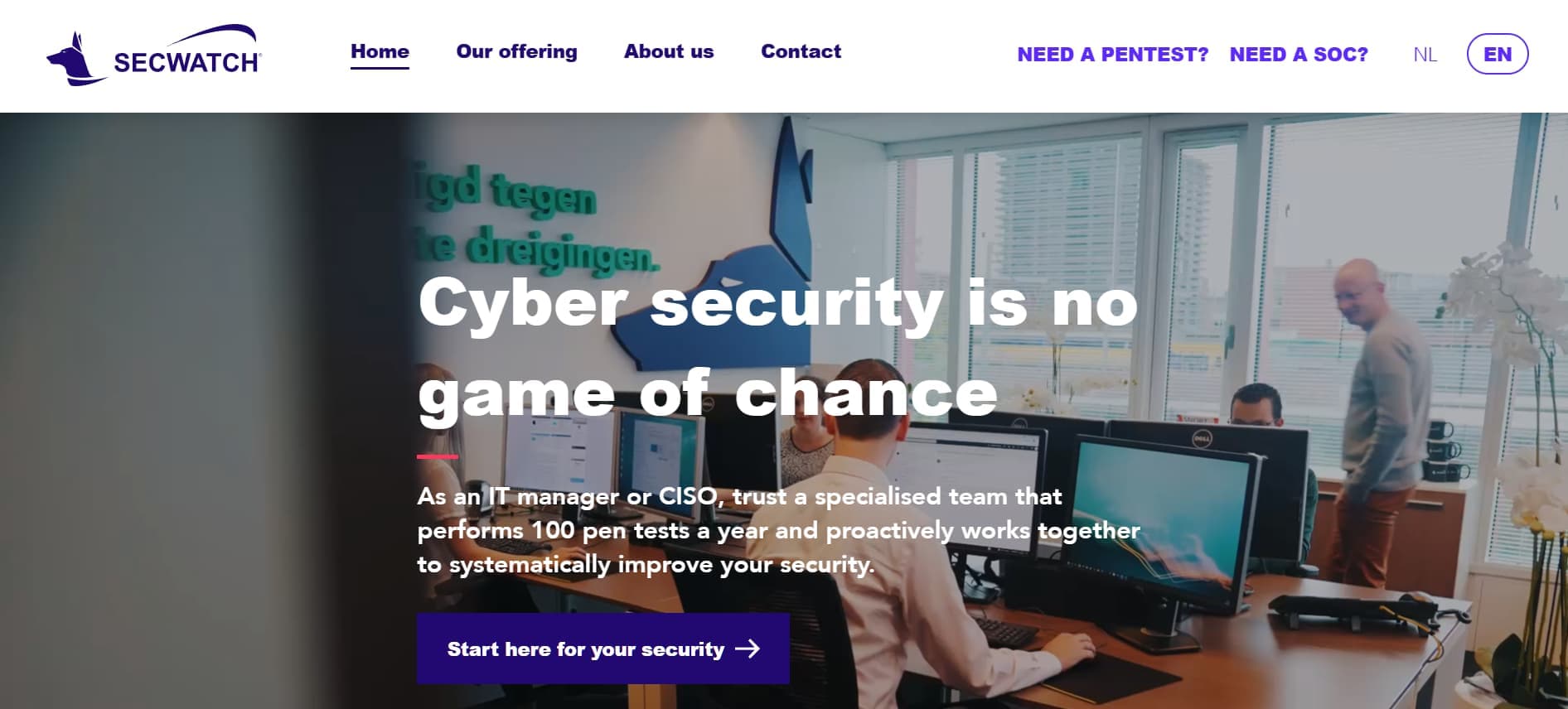 Office environment with employees working at computers, overlaid with the headline “Cyber security is no game of chance” and a purple call-to-action button.