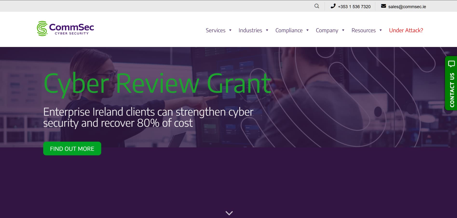 Homepage banner of a cybersecurity company website showing the headline “Cyber Review Grant,” a green “Find Out More” button, navigation menu, and a background image of two professionals analyzing computer screens with purple overlay graphics promoting cyber security funding for Irish enterprises.