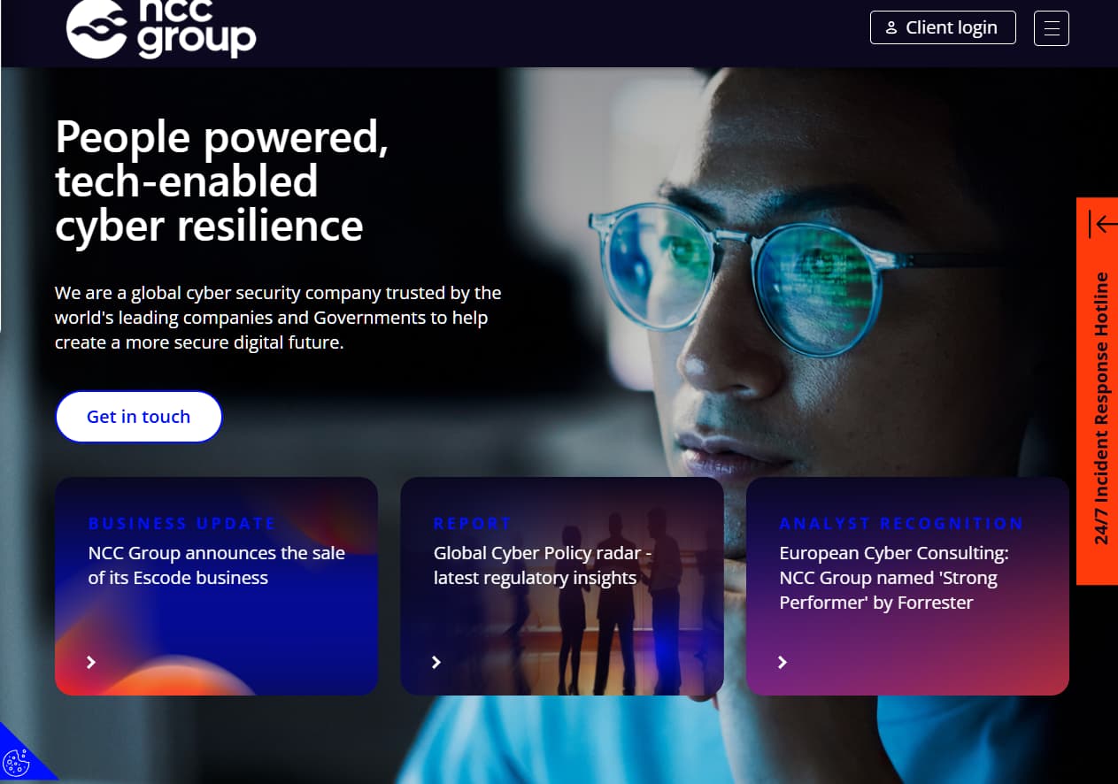 NCC Group cybersecurity hero banner with professional wearing glasses, “People powered, tech-enabled cyber resilience” headline, and get in touch button.