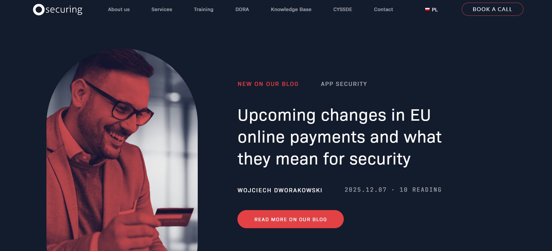 Man smiling while holding a credit card, featured on blog post about upcoming EU online payment security changes.